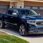 A blue Ram Trucks - 2022 Ram 1500 Limited 10th Anniversary Edition is shown parked in a driveway.