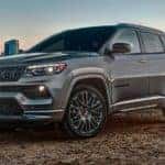 A grey 2022 Jeep Compass High Altitude is shown parked across a bay from a city after leaving a Jeep Compass dealer.