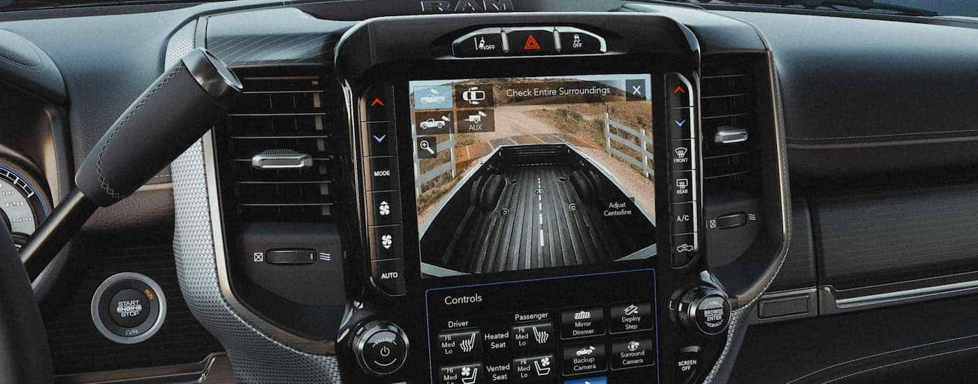 The black interior of a 2022 Ram 2500 shows the backup camera.
