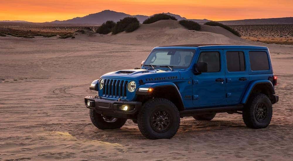 A blue 2021 Jeep Wrangler Rubicon 392 is shown from the side parked in the desert after leaving a Southern California Wrangler dealer.