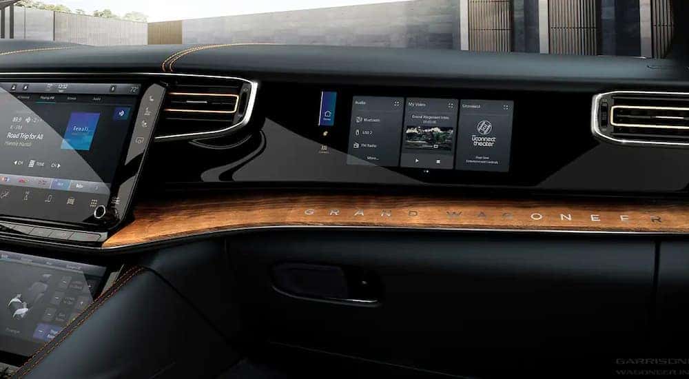 The black interior of a 2022 Wagoneer shows the dashboard screen at a California Wagoneer dealer.