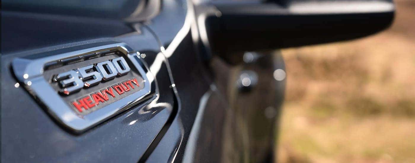 A close up shows the badge on a black 2022 Ram 3500.