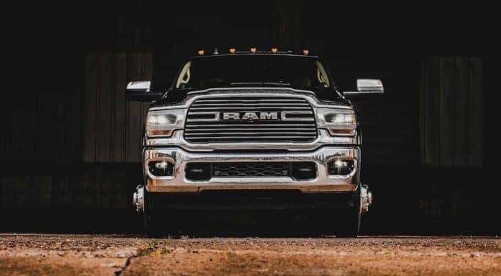 A black 2022 Ram 3500 is shown from the front parked in a warehouse after visiting a Ram 3500 dealership.