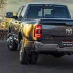 A grey 2022 Ram 3500 Limited is shown from the rear at a Ram 3500 dealership.