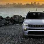 A grey 2022 Jeep Compass Sport is shown from the front parked near a California Jeep Compass dealer.