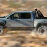 A silver 2022 Ram 1500 TRX is shown from the side off-roading in the desert.