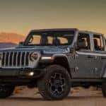 A grey 2021 Jeep Wrangler 4xe is shown from the front parked in a desert.