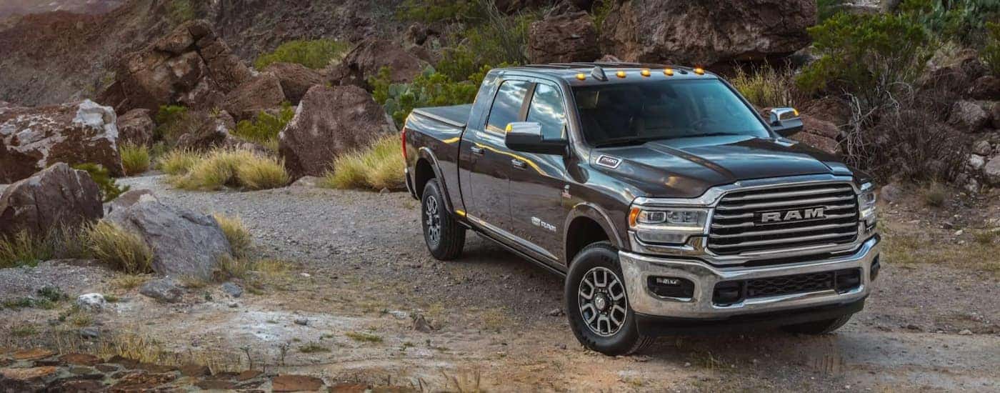 A grey 2021 Ram 1500 Limited Longhorn is shown after leaving a used work truck dealer.