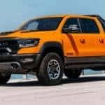 An orange 2022 Ram TRX Ignition Edition is shown parked near a California Ram TRX dealer.