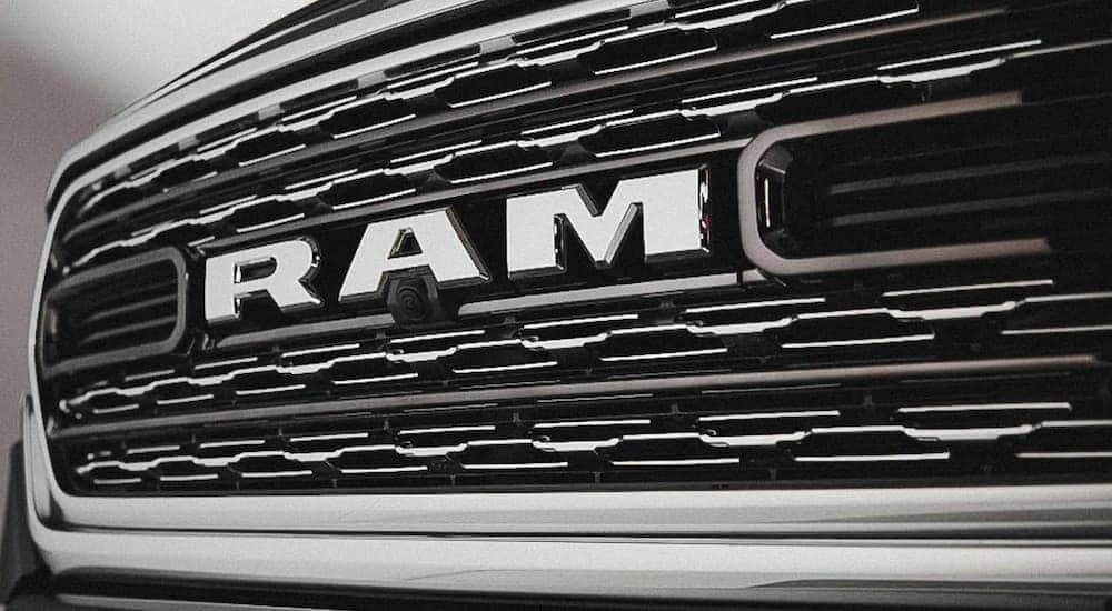 A close up of the Ram badge is shown at a southern California diesel truck dealer.