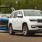 A white 2022 Wagoneer is shown towing a boat.