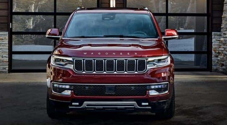 A red 2022 Wagoneer is shown parked in front of a modern garage.
