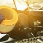 A mechanic is shown changing a filter during a Ram truck service.
