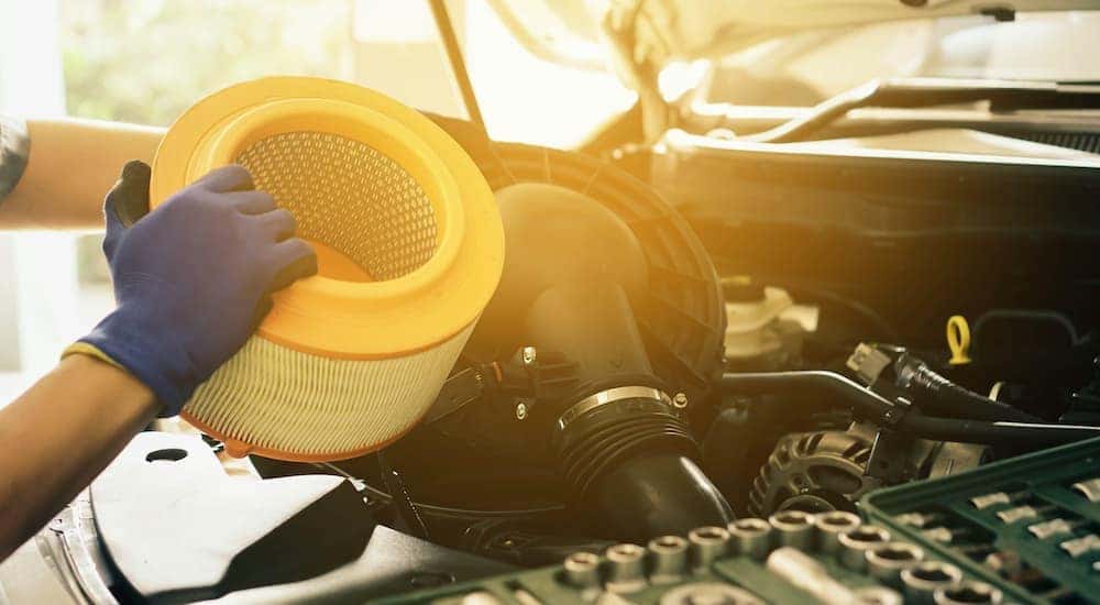 A mechanic is shown changing a filter during a Ram truck service.
