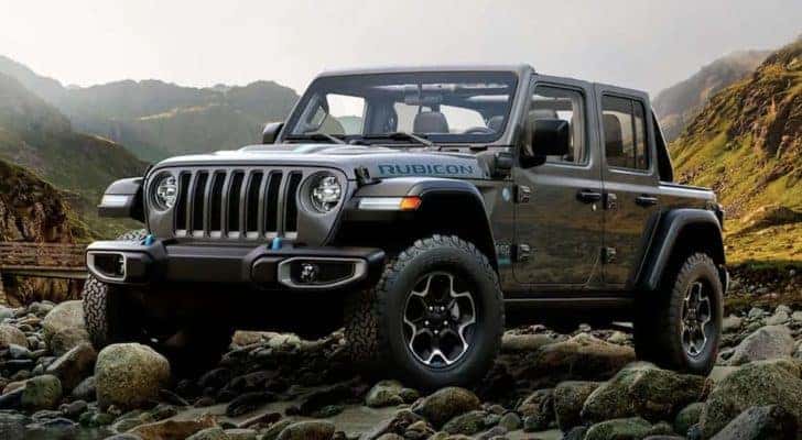 A grey 2022 Jeep Wrangler 4xe is shown from the front parked in a rocky area.