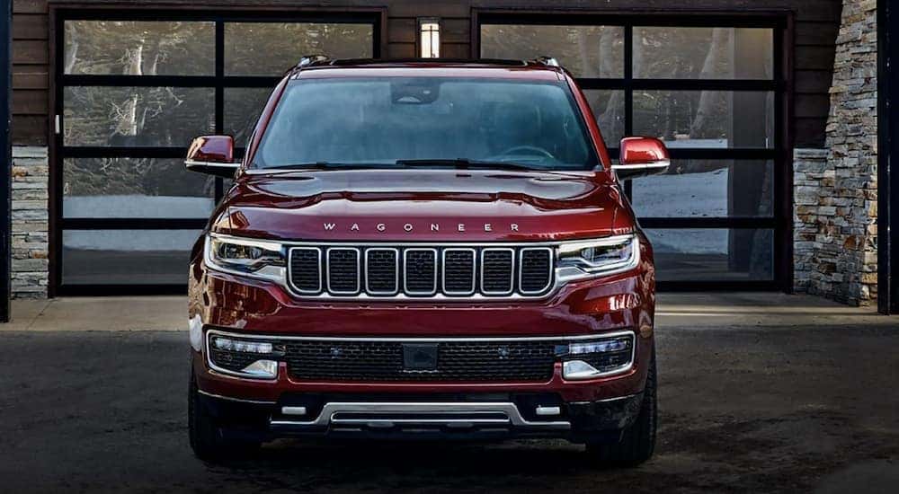 A red 2022 Wagoneer is shown front parked in front of a building.