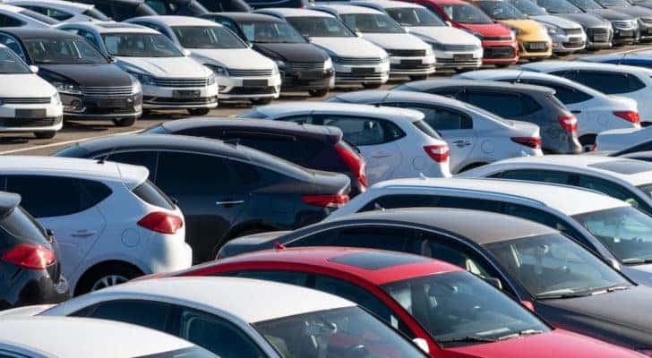 A car lot full of cheap cars for sale is shown from above.