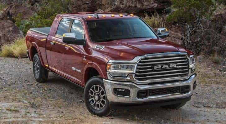 A maroon 2022 Ram 2500 is shown from the front parked on a dirt road.