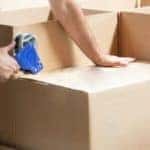 A person is shown packing boxes.