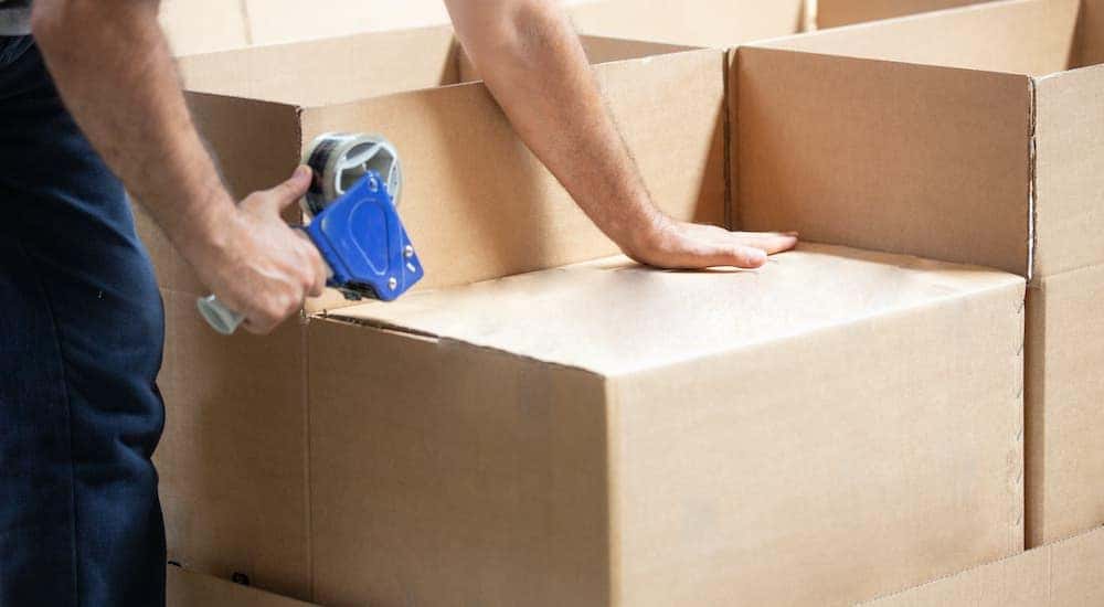 A person is shown packing boxes.