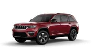A maroon 2023 Jeep Grand Cherokee 4xe is angled left.