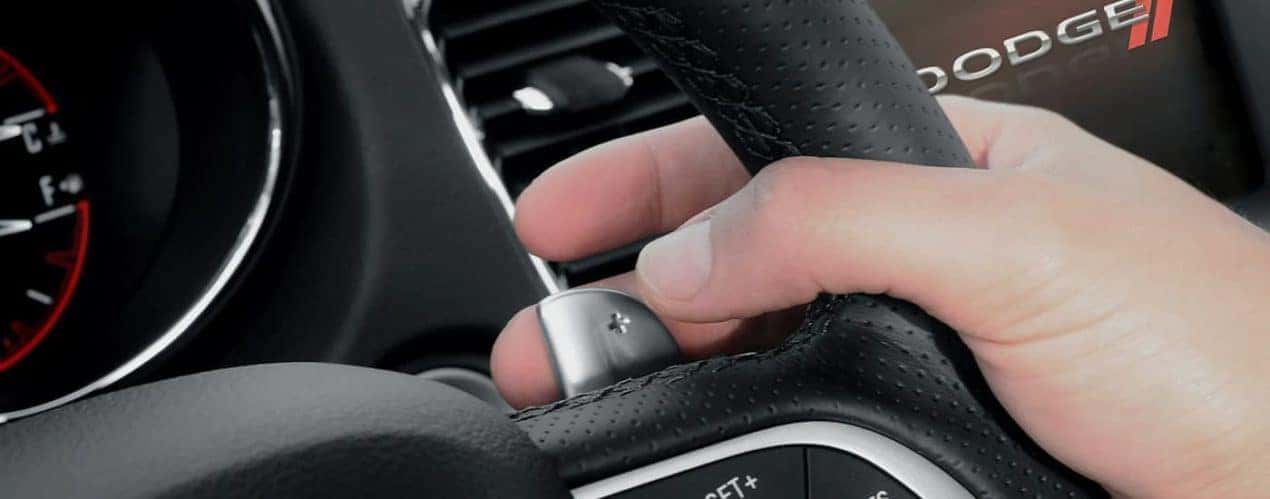 A close up of the paddle shifter on a 2022 Dodge Charger is shown during a 2022 Dodge Charger vs 2022 Chevy Camaro comparison.