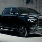 A black 2022 Ram 1500 is shown from the front at an angle after leaving a dealer that had used Ram trucks for sale.
