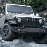 A silver 2020 Jeep Wrangler Willys is shown from the front in a rocky area after leaving a Jeep dealership in Los Angeles.