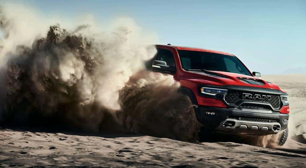 A red 2021 Ram TRX is shown off-roading in the desert.