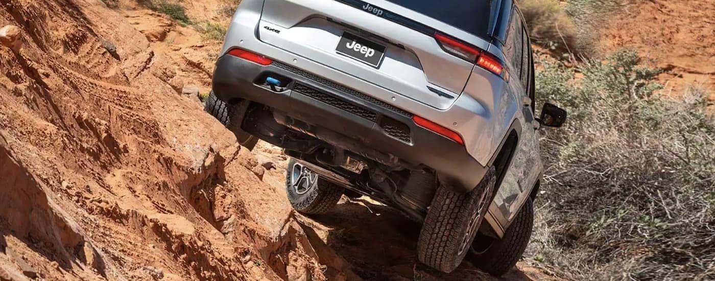 A silver 2023 Jeep Grand Cherokee 4xe is shown from the rear after searching 'all-electric Jeep vehicles.'