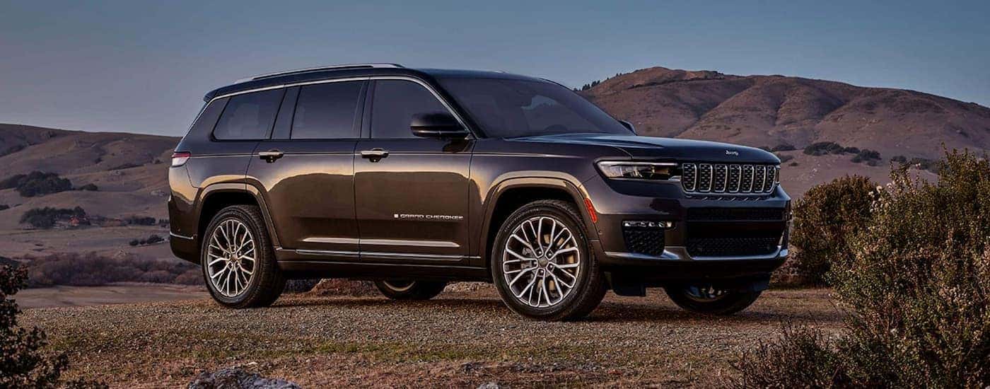 A black 2023 Jeep Grand Cherokee is shown parked in a desert.
