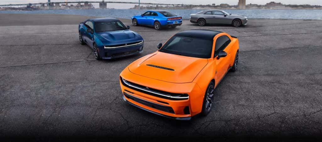 Variety of 2026 Dodge Charger Daytonas parked alongside a body of water