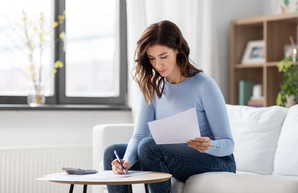 Woman signing pre-owned financing contract