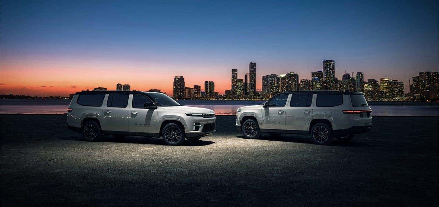 White 2026 Jeep Grand Wagoneer L in front of cityscape