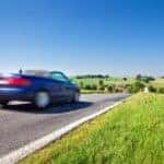Customer test-driving a high-mileage used car