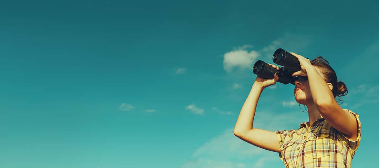 Person with binoculars looking for used SUV deals