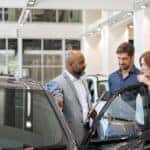 Customer talking to salesperson at an auto dealership