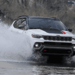 A Jeep Trailhawk model fording water