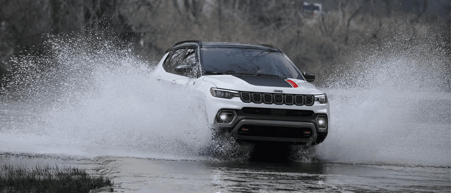 A Jeep Trailhawk model fording water