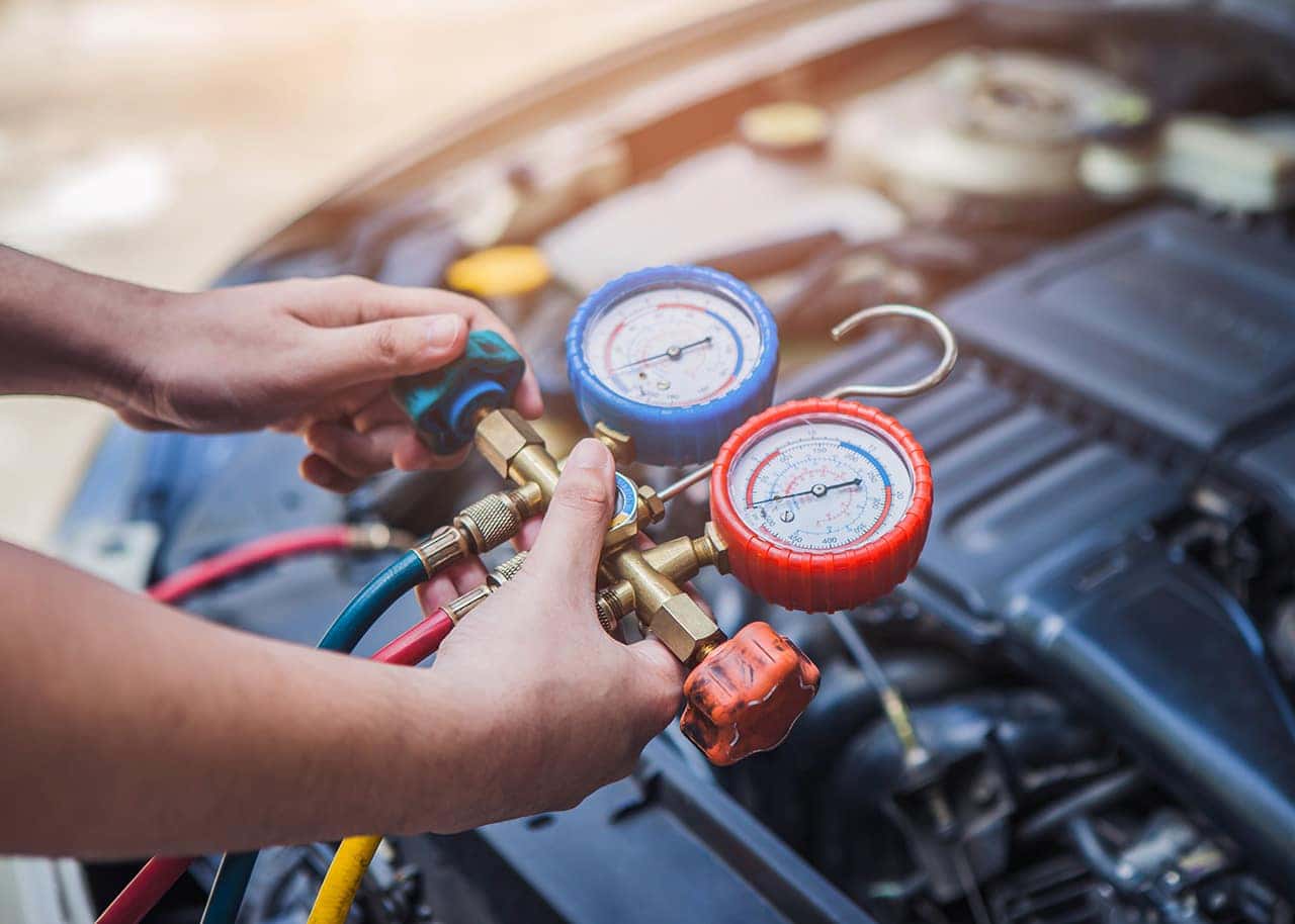 Jeep service technician testing an A/C system