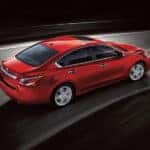 Red 2019 Nissan Sentra driving on black background