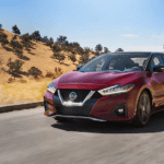 A red 2019 Nissan cruises the California hills outside Huntington Beach
