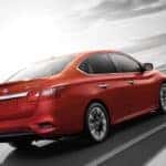A red 2019 Nissan Sentra on a test drive from a Nissan Dealer in Orange County