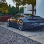 gray Porsche 911 GT parked on a gravel driveway