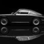 A 1964 Porsche 911 made by Auto Art, set against a solid black background. Low key/black & white image.