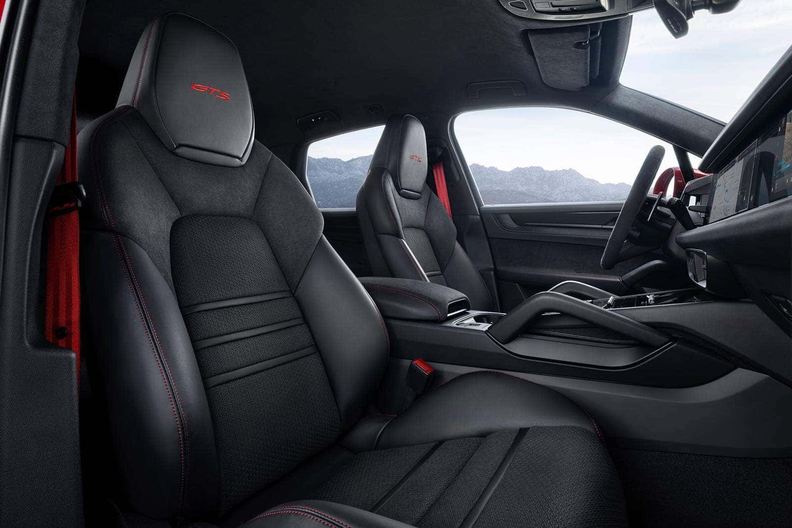interior of the 2025 porsche cayenne suv with black interior fabric and red stitching
