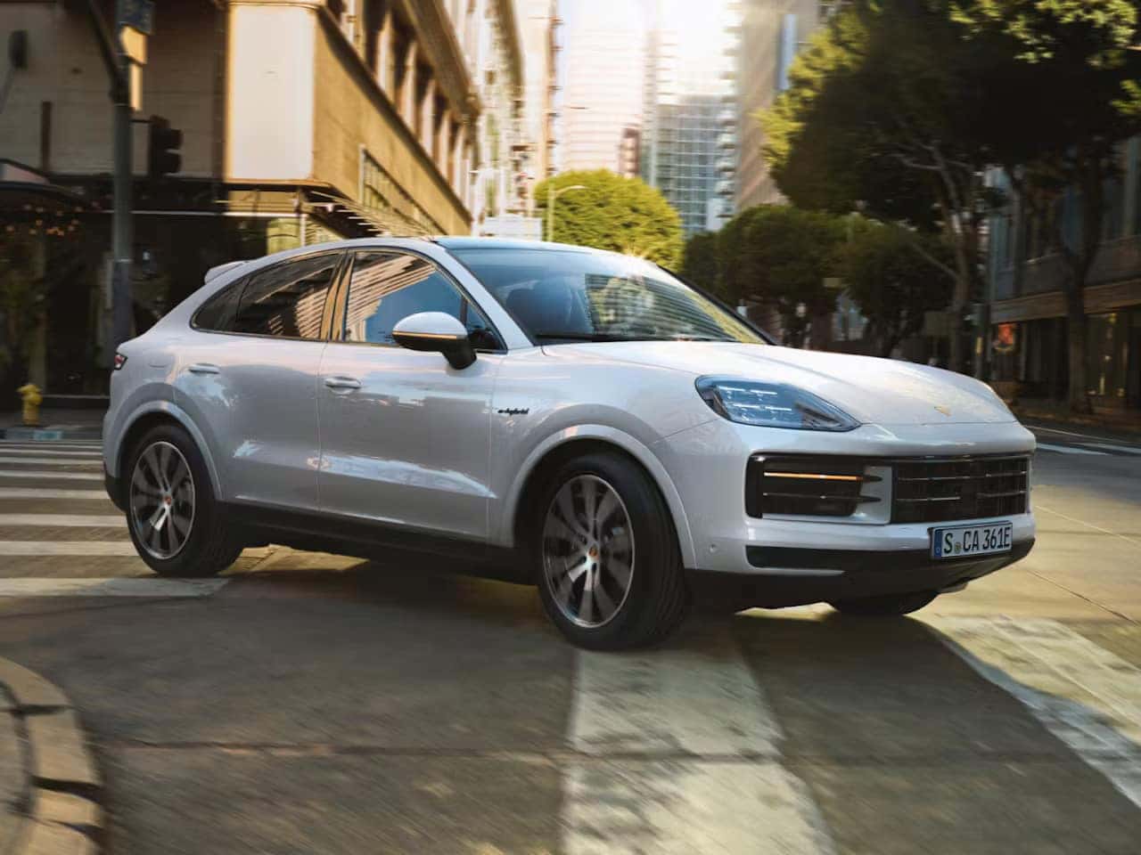 a white cayenne coupe parked in the city