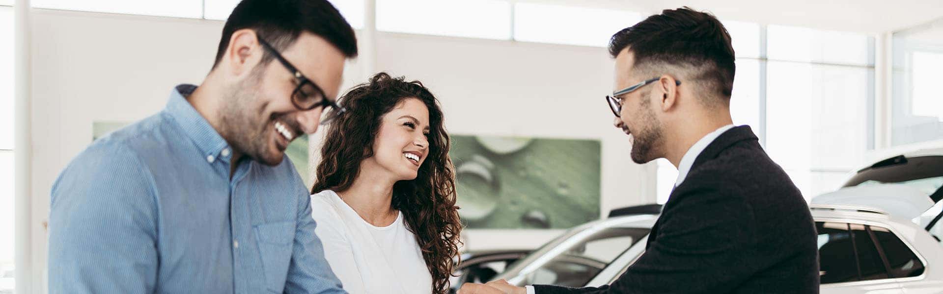 Middle age couple choosing and buying car at car showroom. Car s