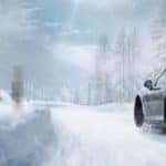 Porsche driving through the winter snow