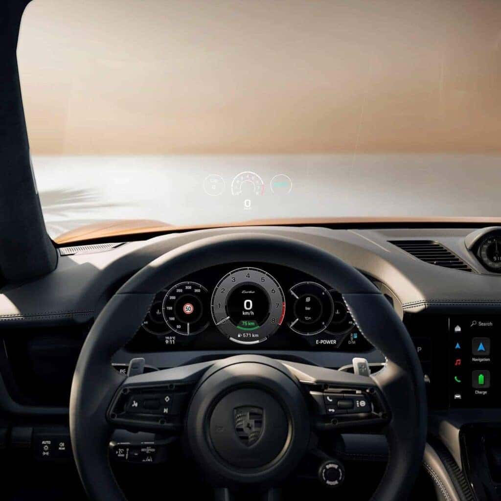 Close-up of the Porsche Panamera steering wheel and digital dashboard, featuring cutting-edge technology and driver-focused controls.